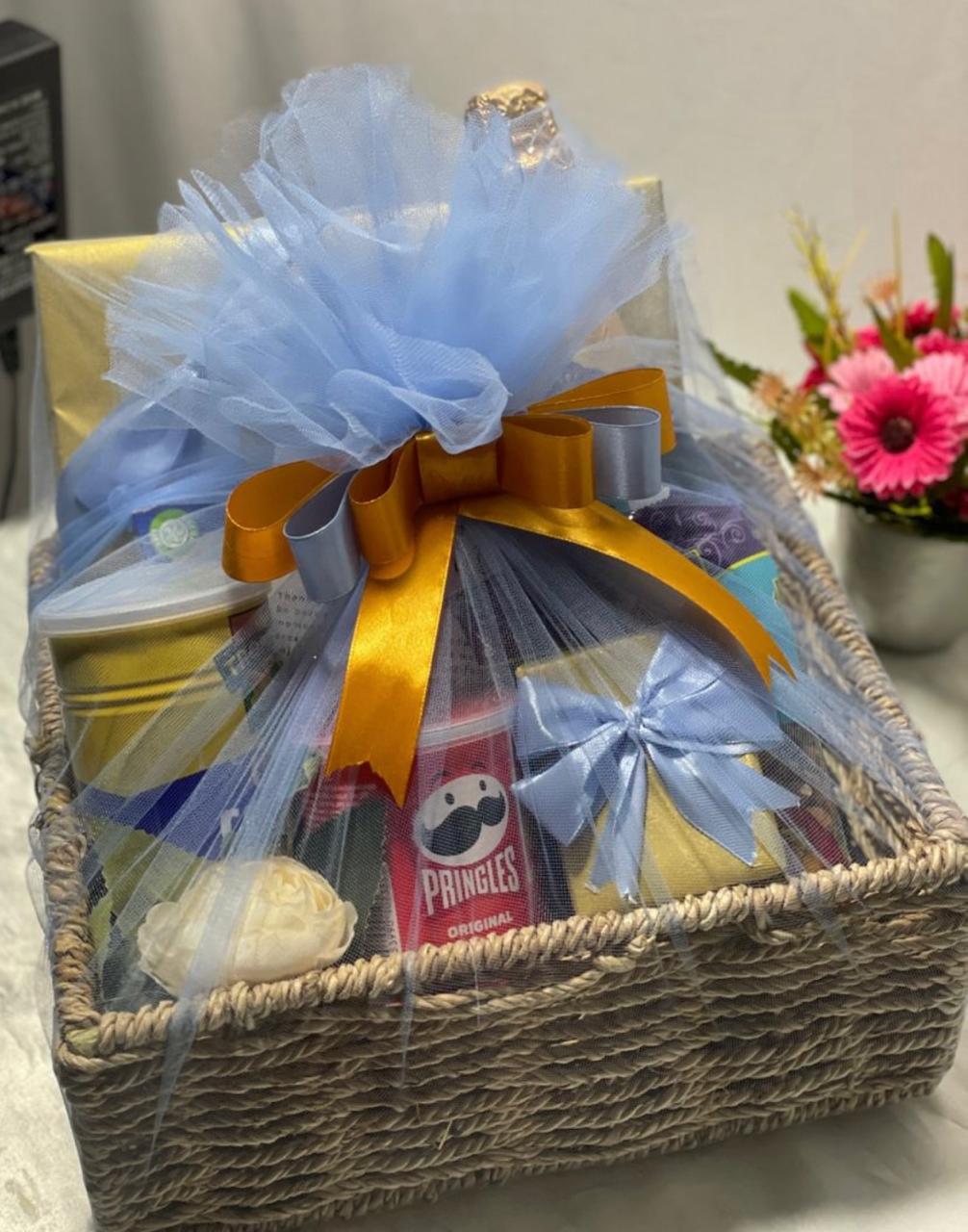 Wicker basket with transparent wrap and blue ribbon